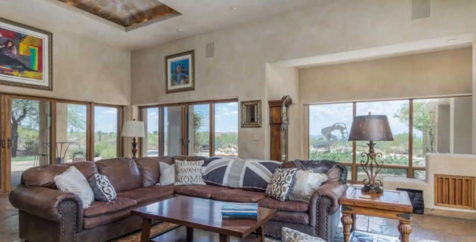 Bright living room with large windows and leather sofas