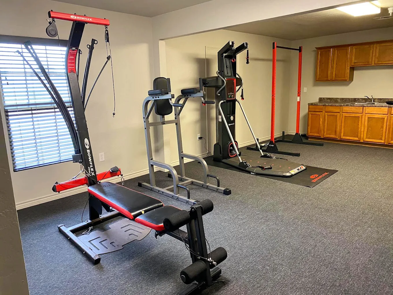 Fitness room with strength training and exercise equipment