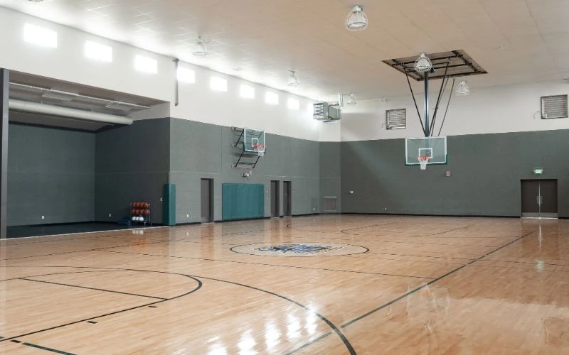 Spacious gym with polished wood floor and hoops