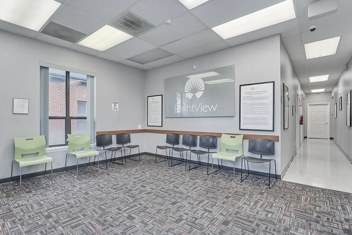 Bright waiting area with chairs and BrightView wall sign
