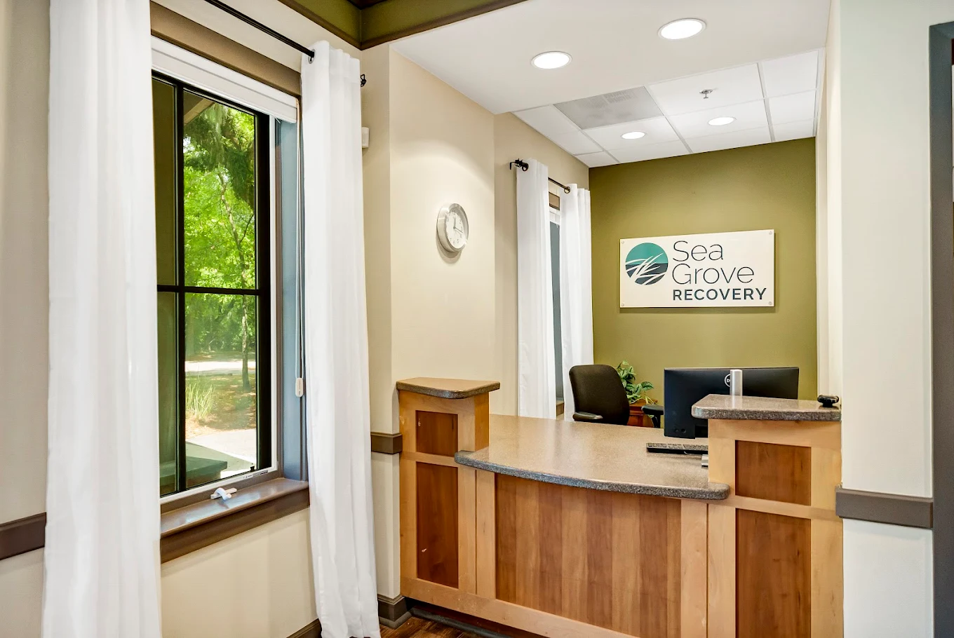 Front desk reception area with large windows