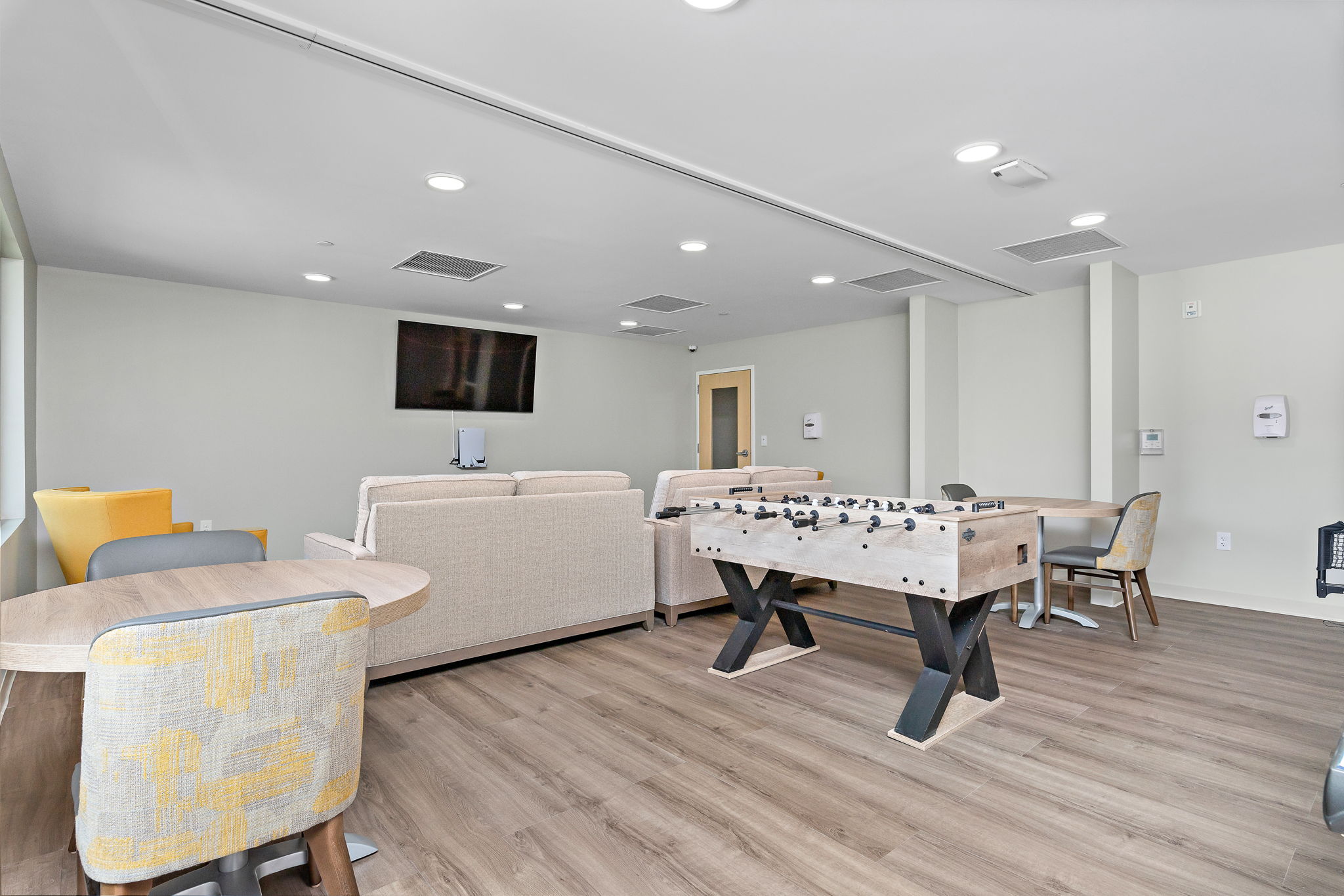 Room with foosball table, TV, and seating area
