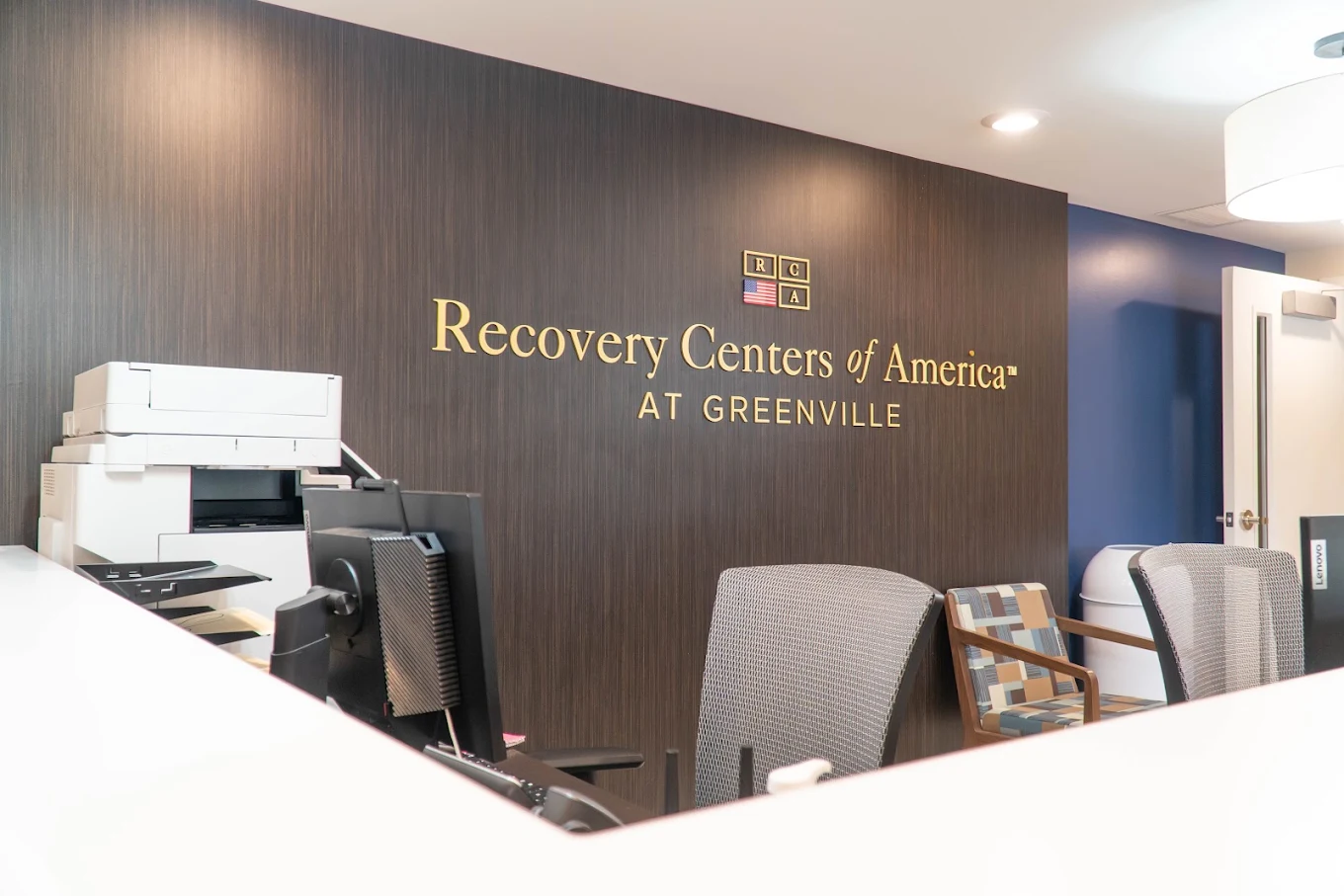Reception desk with Recovery Centers of America wall signage
