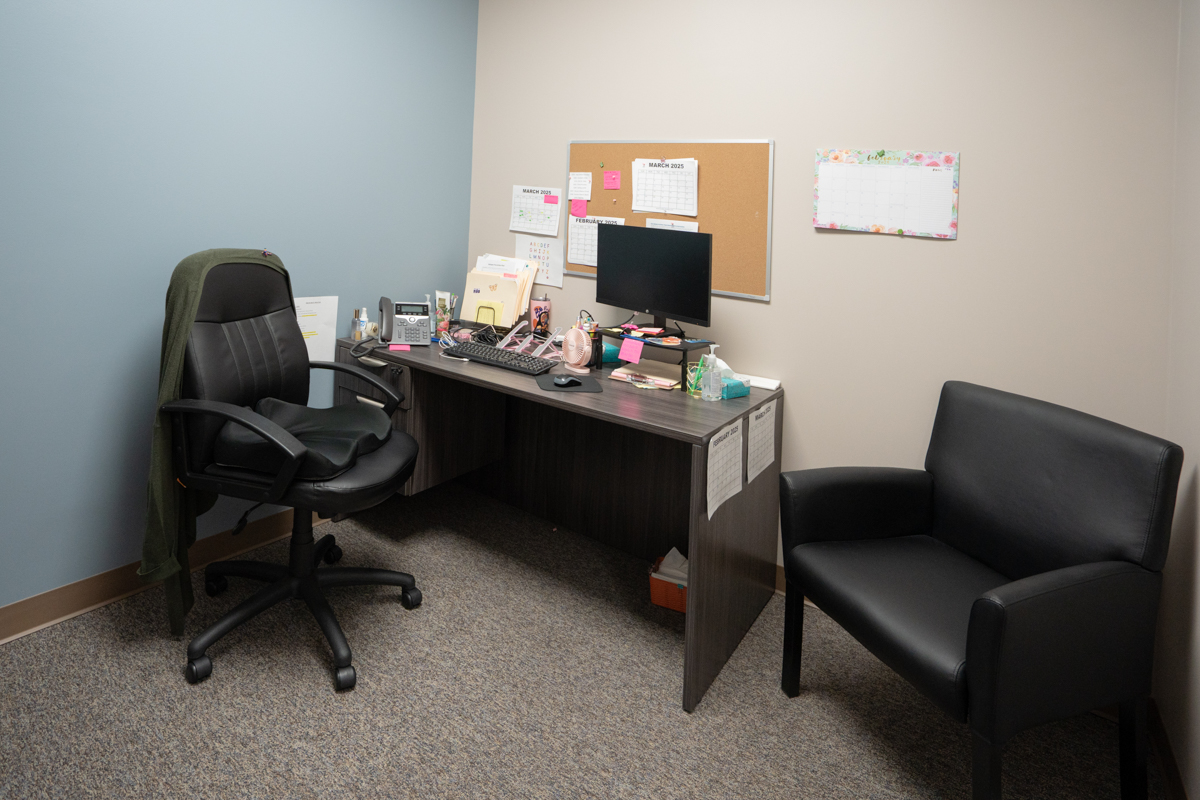 Counseling office with desk, computer, and guest chair