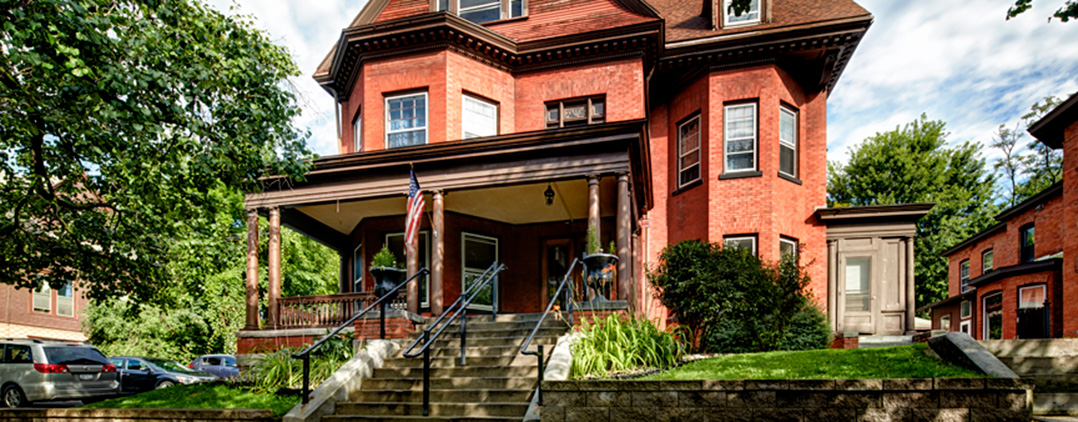 Historic red-brick residence with porch and front steps