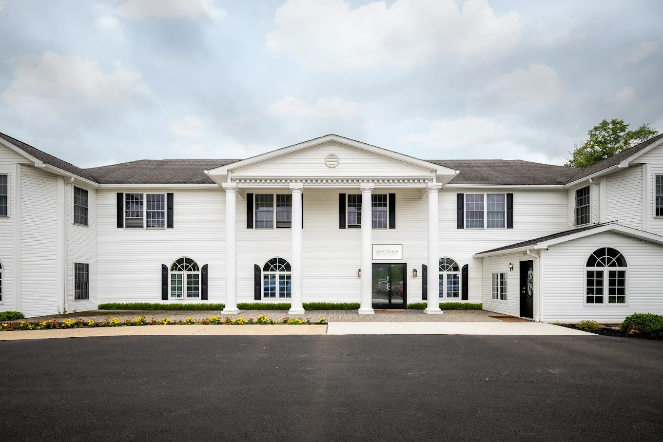 White two-story rehab facility with columned front entrance