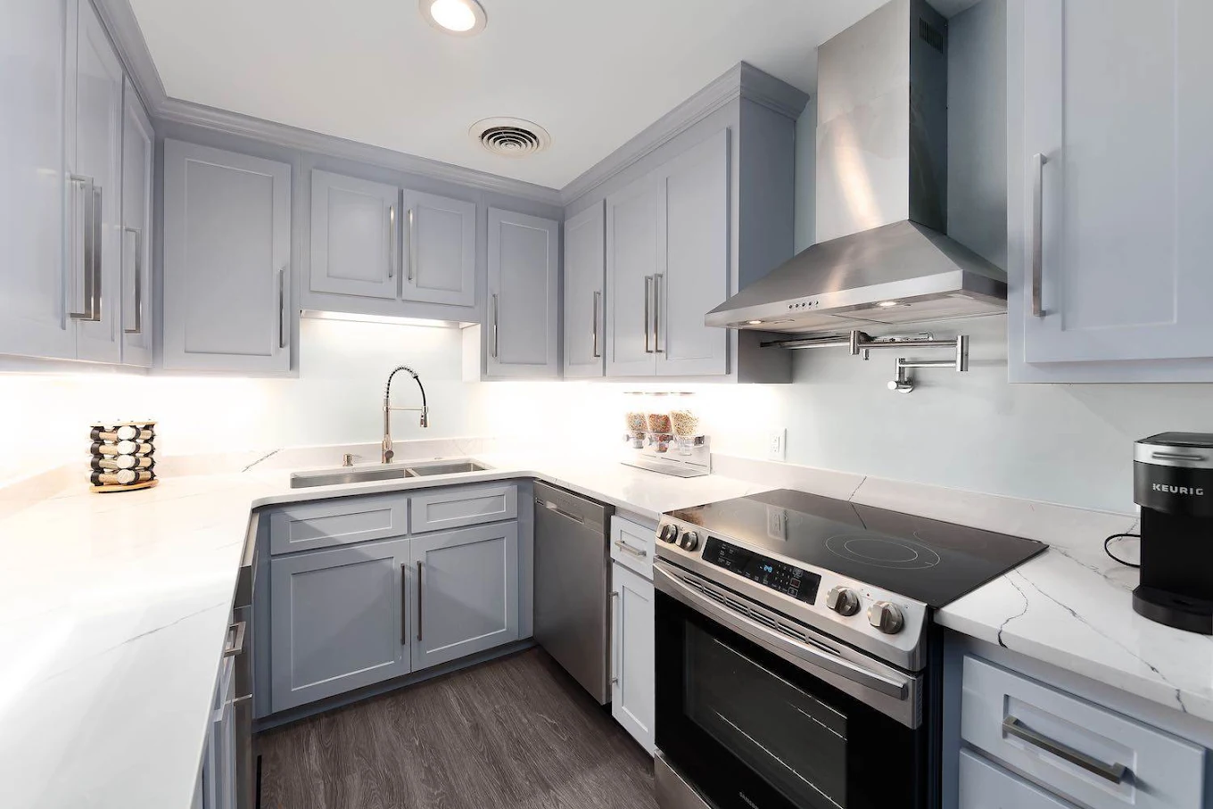 Modern kitchen with stove, sink, cabinets, and countertops