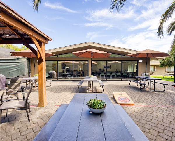 Outdoor patio with picnic tables and shaded seating