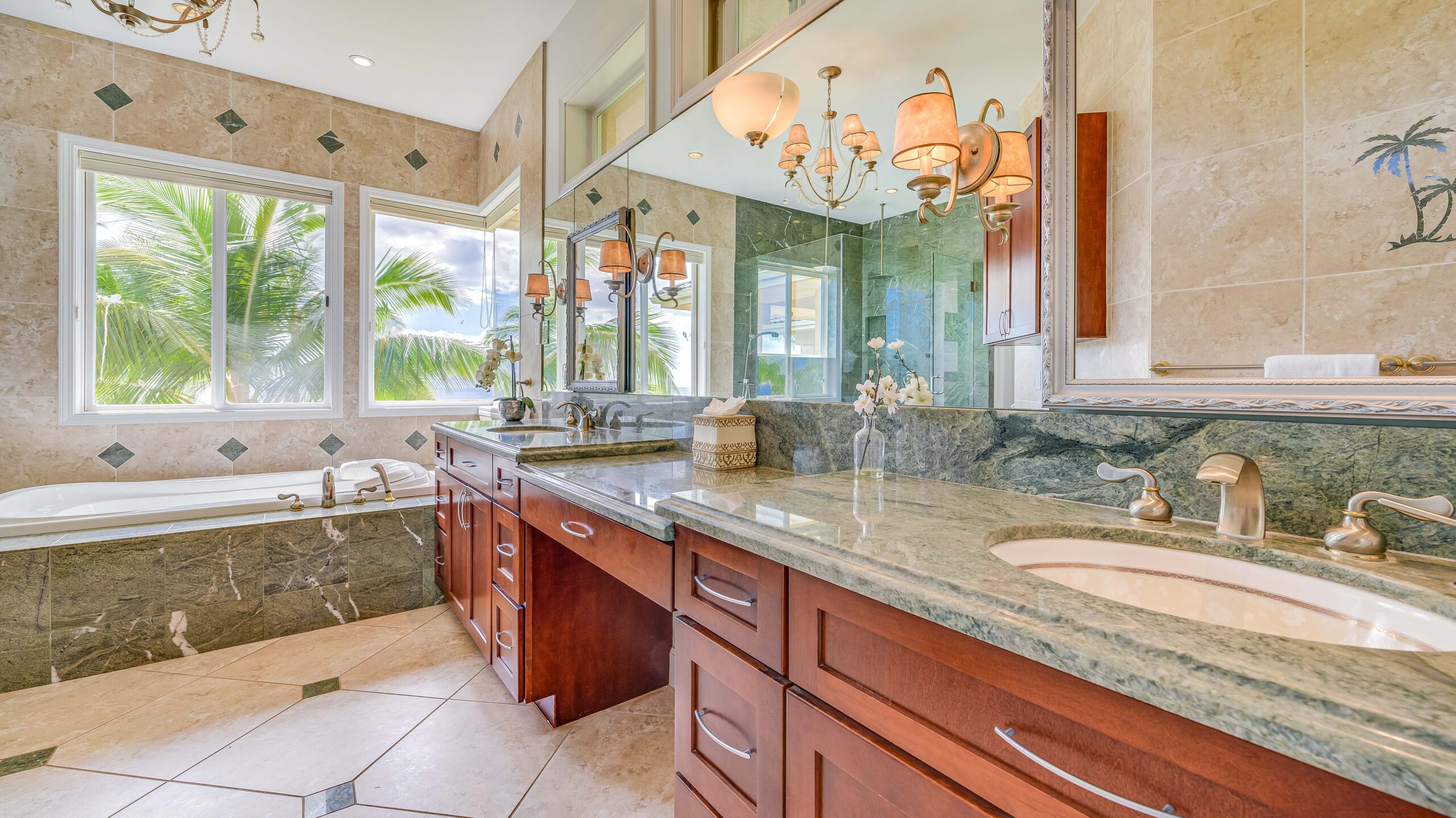 Spa-style bathroom with dual vanities, soaking tub, and natural stone finishes