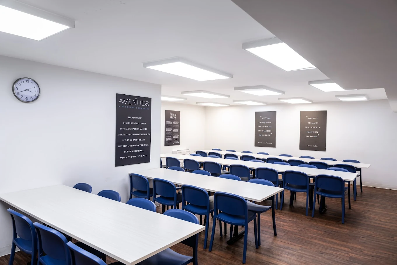 Bright group room with circle of chairs and 12-step display