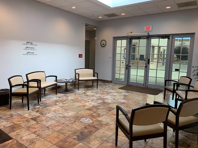 Seating area with armchairs near front entrance