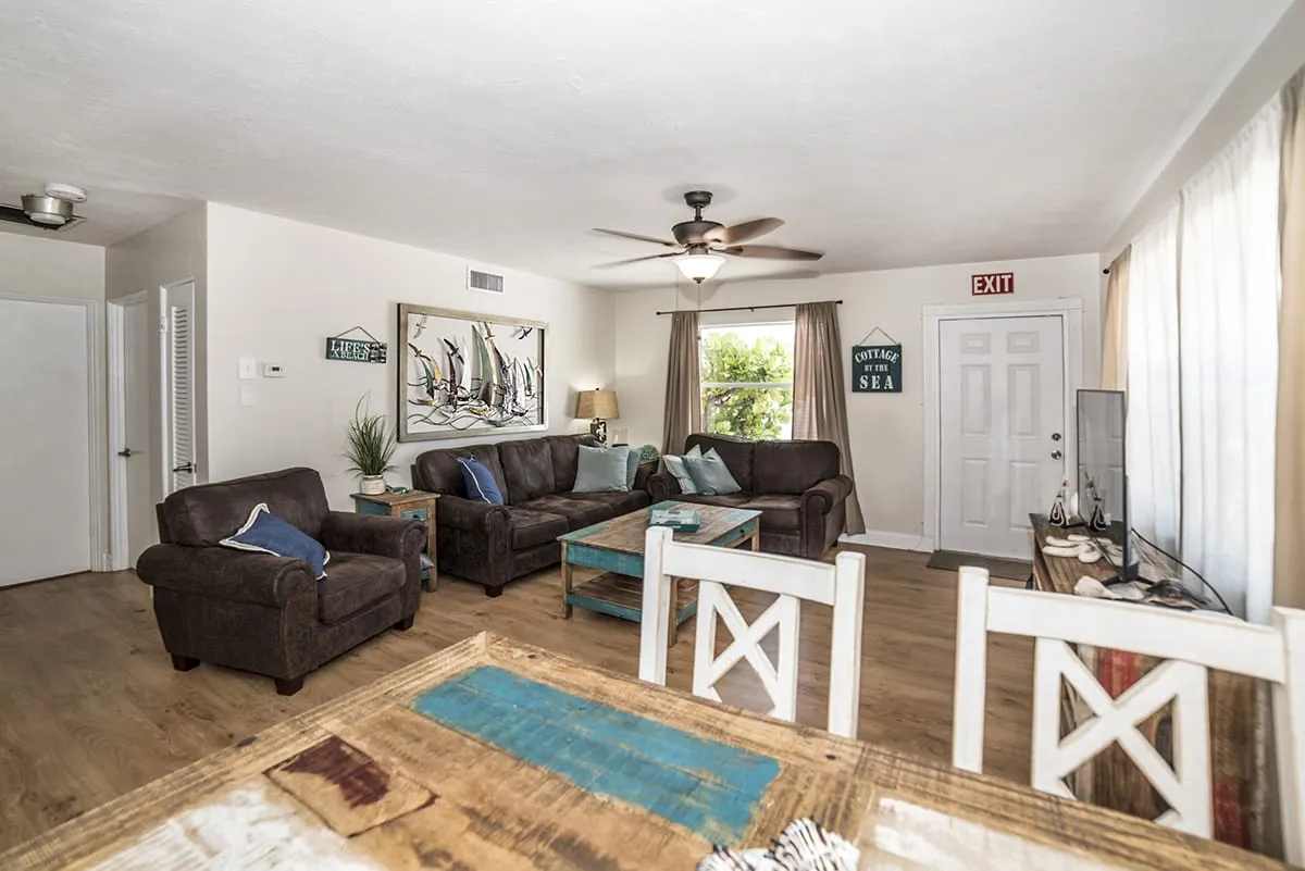 Leather sectional sofa and ceiling fans in open living space