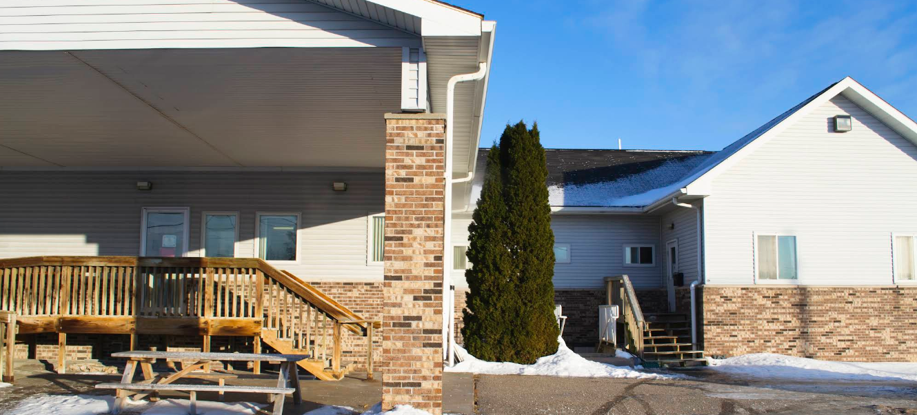 Exterior view of rehab facility building in winter with snow outside
