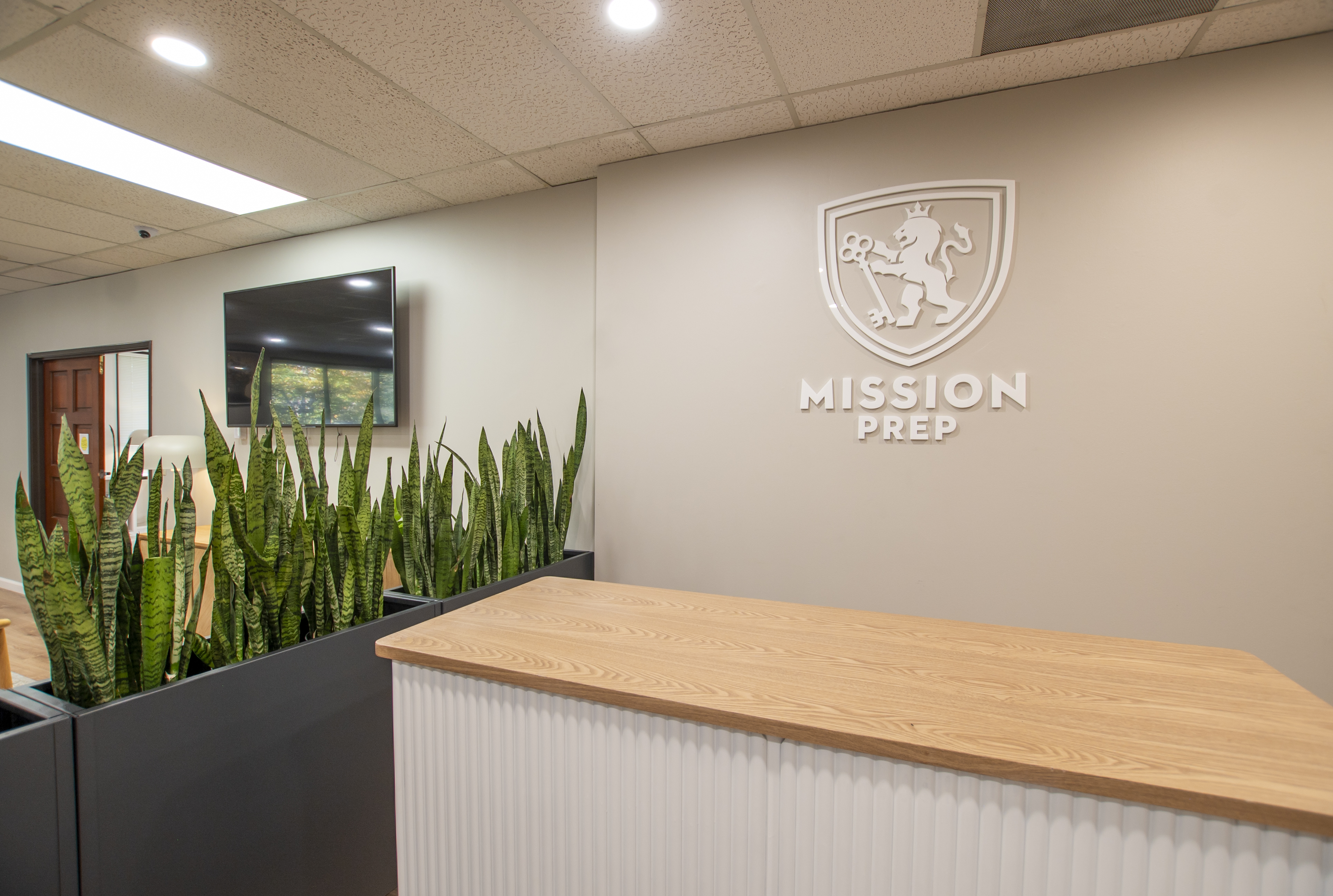 Mission Prep logo wall and wood reception counter