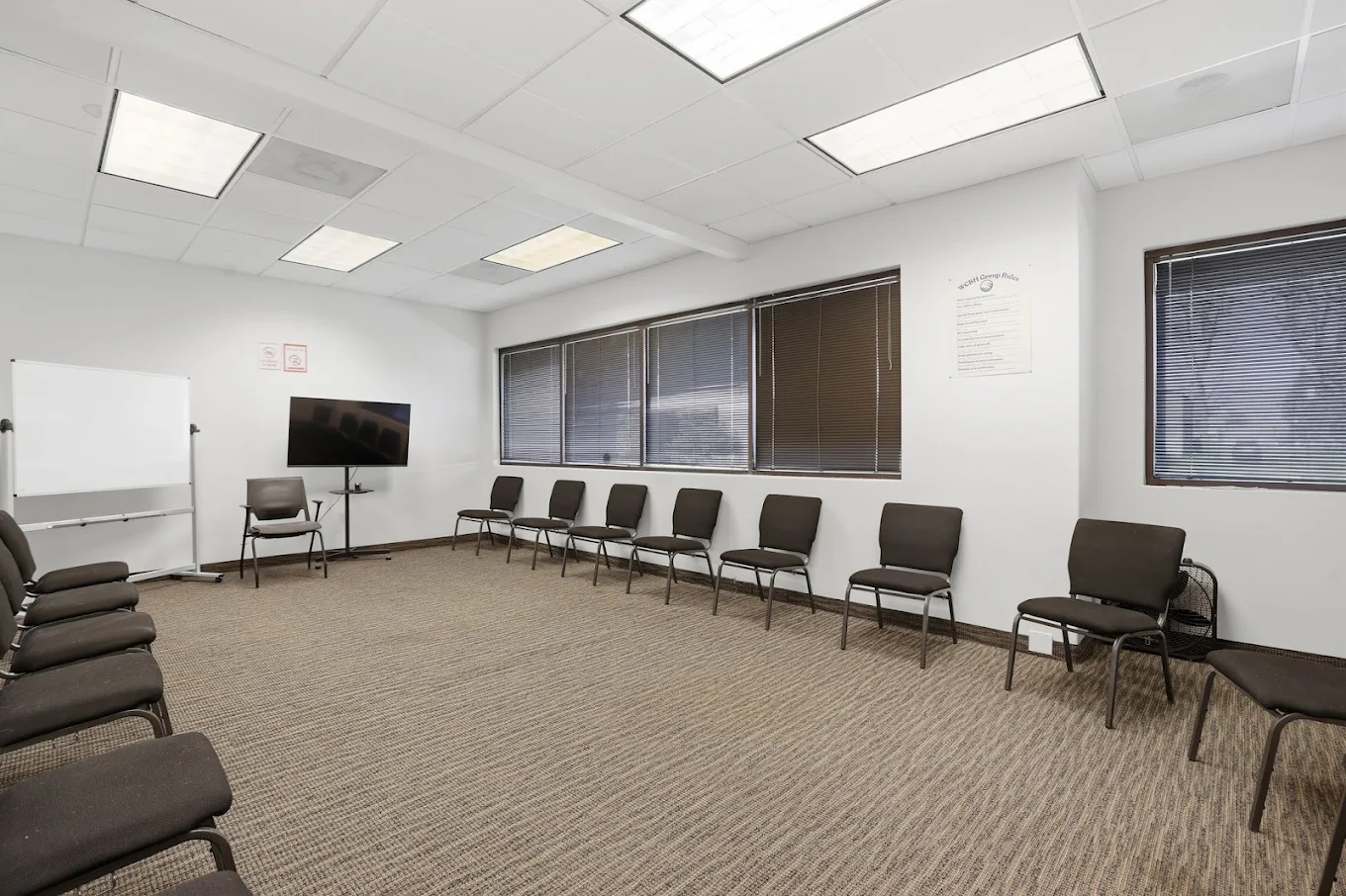 Group therapy room with chairs arranged around an open space