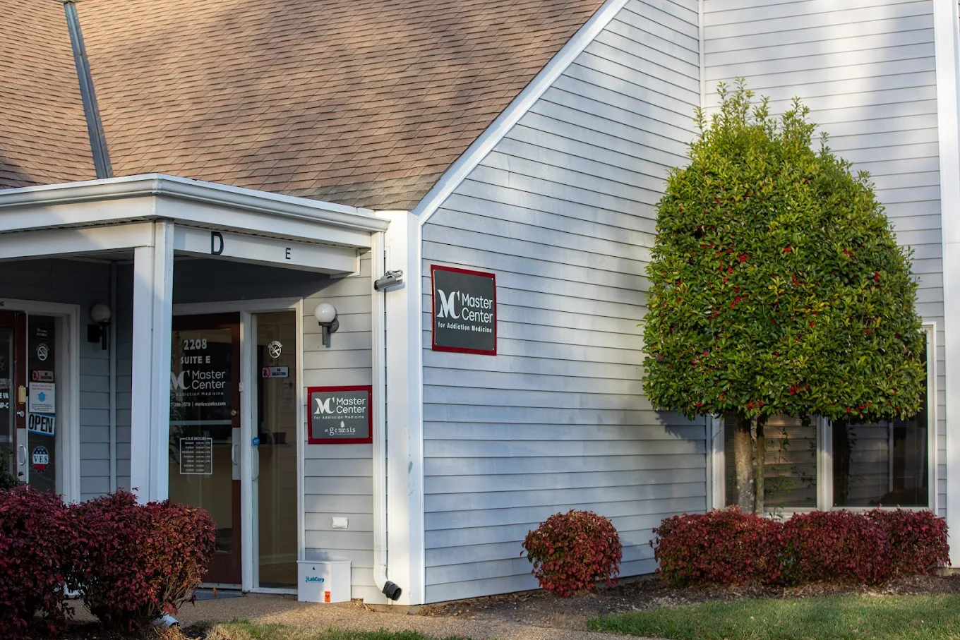 Facility exterior with entrance, signage, and landscaping