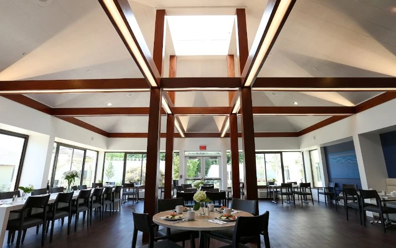 Dining area with wood beams and skylight ceiling