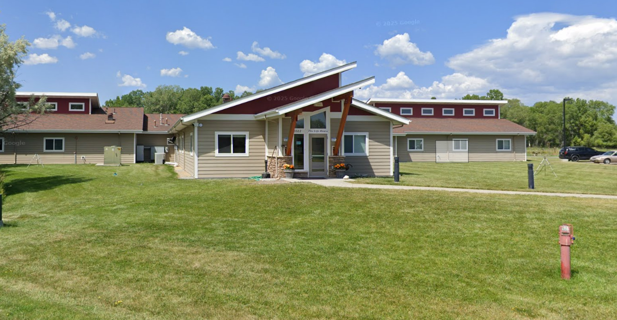Wide view of Life House campus with entrance and grassy yard