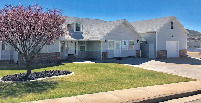 Rehab center with blooming tree and green lawn