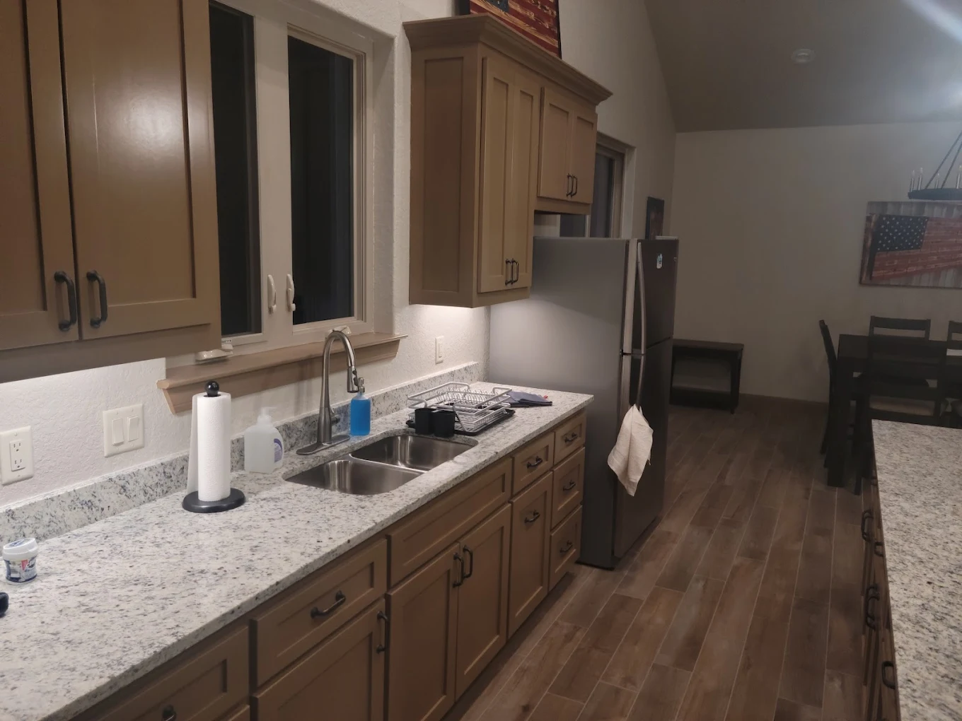 Granite kitchen counters with double sink and dining area