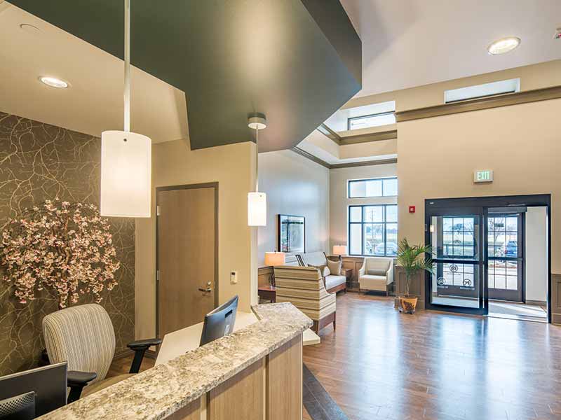 Reception and welcome area inside Mount Regis Center with front desk and seating