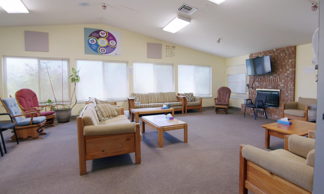 Spacious room with sofas and chairs arranged for group meetings