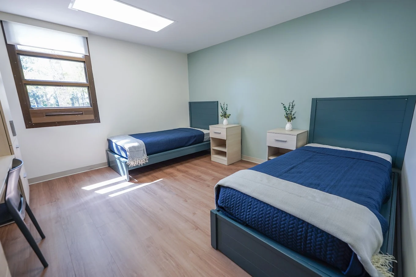 Shared bedroom with two beds and bedside tables