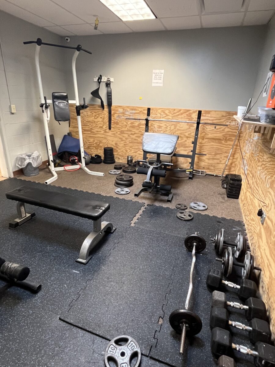 Workout room with benches, dumbbells, and barbells