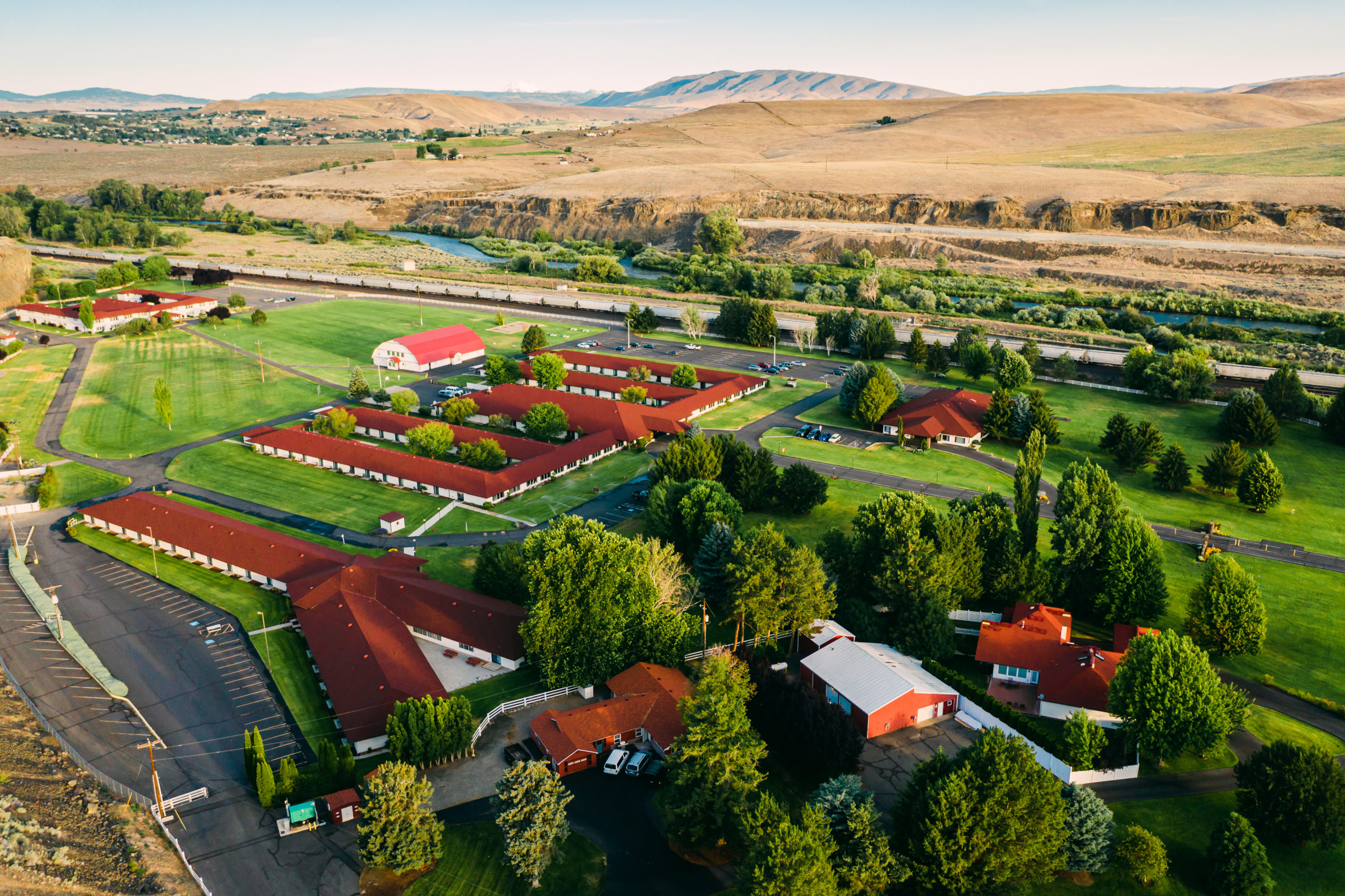 Aerial view of ranch buildings and hills