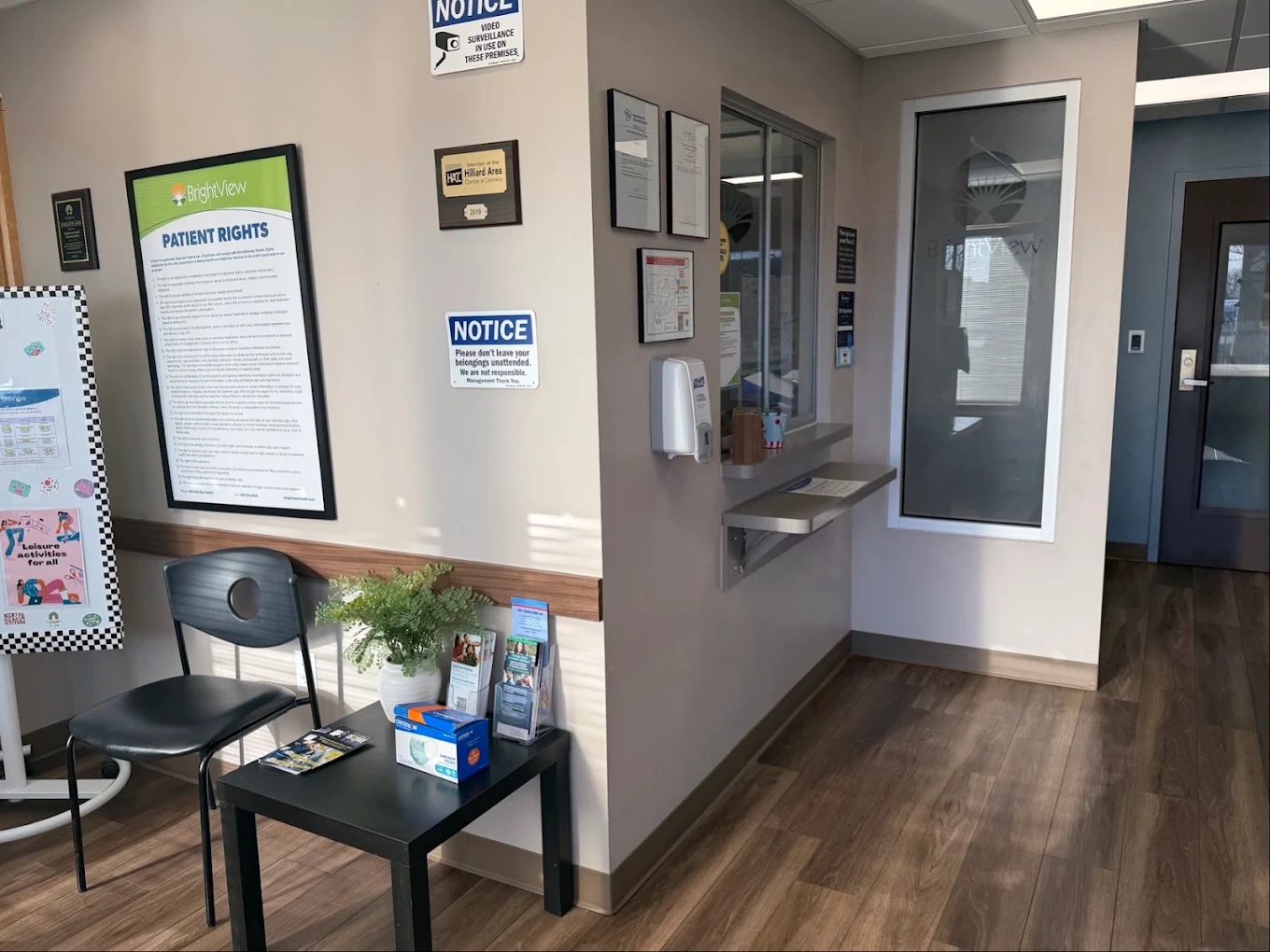 BrightView Health check-in area with service window, patient-rights information, chair, brochures, and hallway