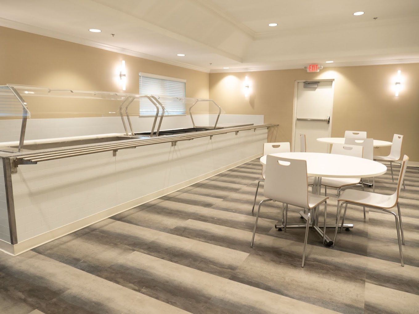 Dining area featuring a tables, chairs, and a servers station.