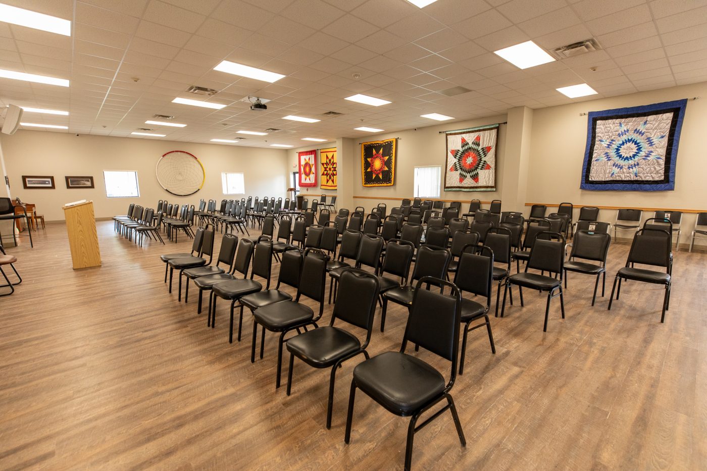 Large meeting hall with rows of chairs for recovery meetings and group therapy sessions