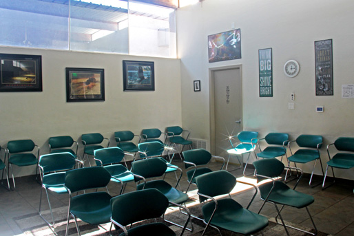 Group therapy room with teal chairs and natural sunlight