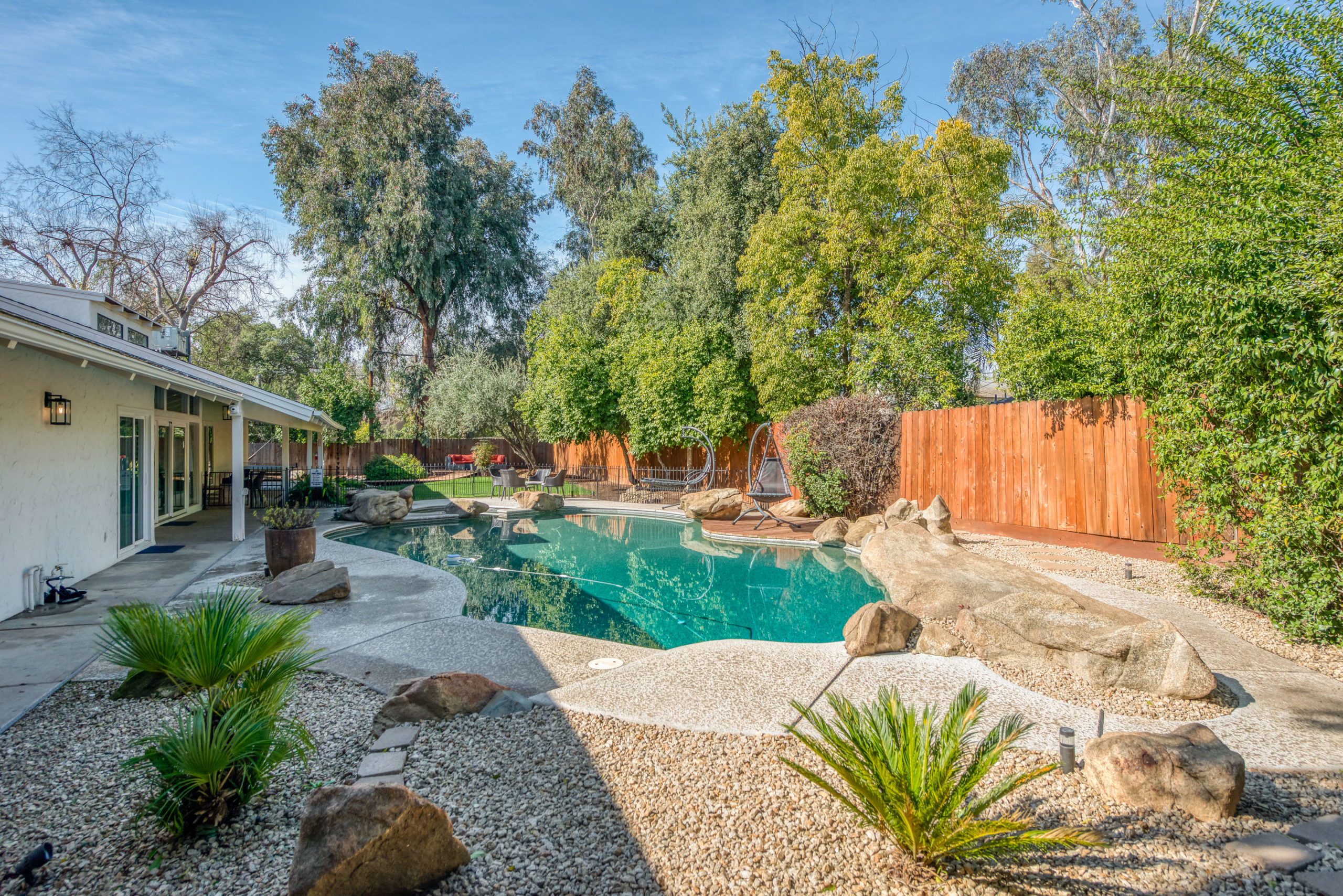 Backyard pool with landscaping and patio area