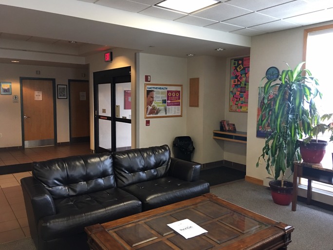 Waiting room with couch, table, and natural light
