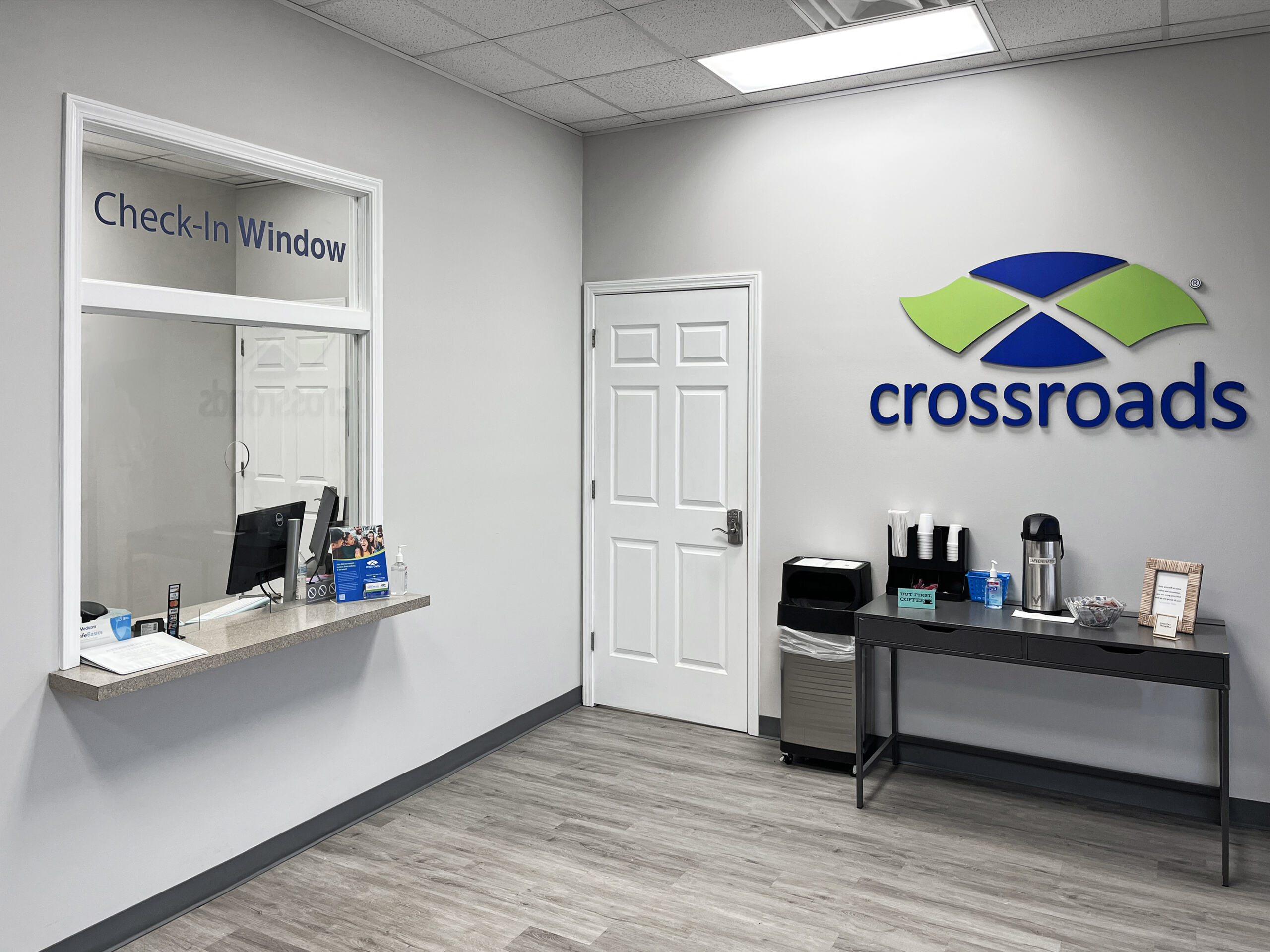 Check-in window and coffee station in clinic lobby