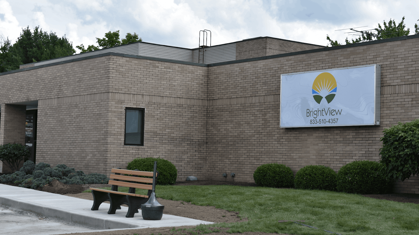 Brick exterior of BrightView Massillon with sign and bench