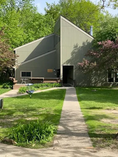 Front view of rehab center with sloped roof and trees around