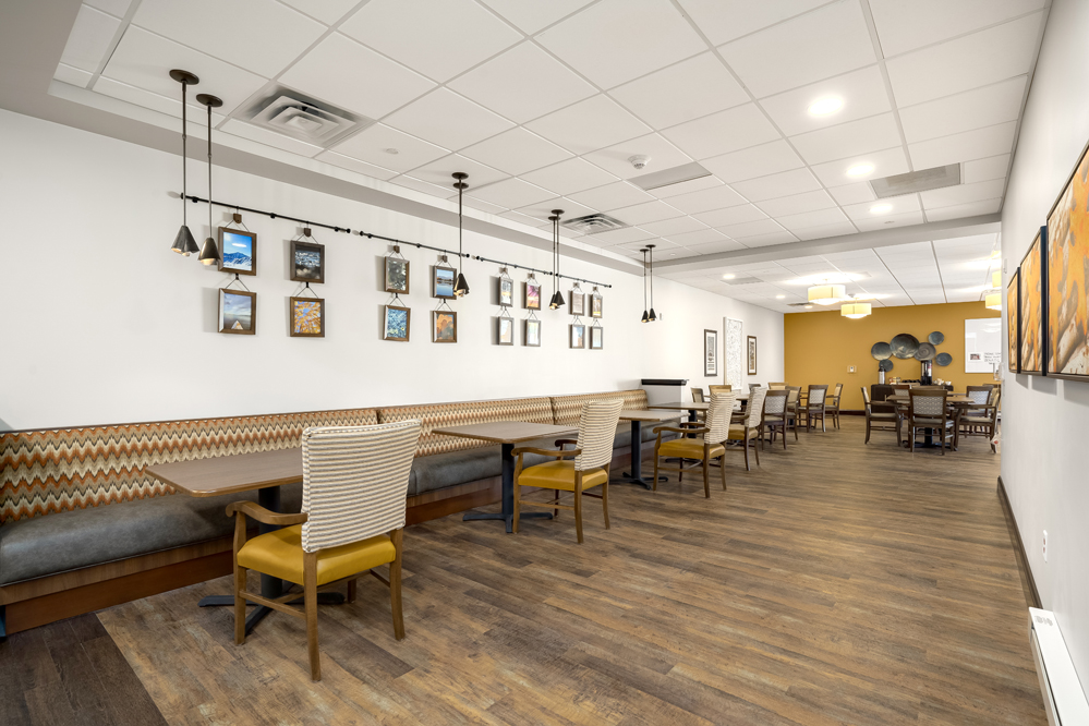 Community dining room with tables and booth seating