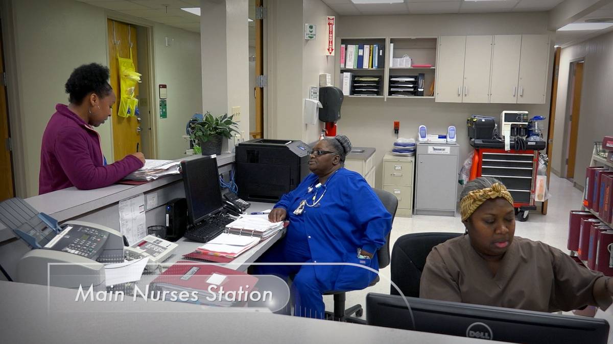 Nurses working at a central hospital workstation
