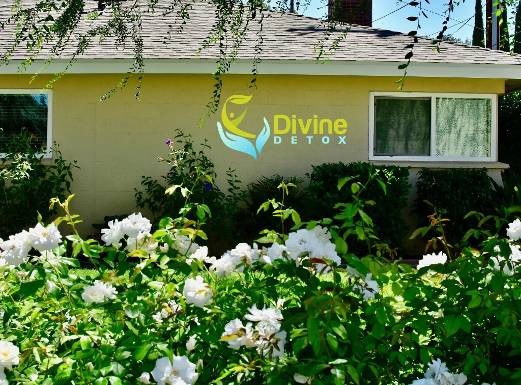 Flower garden in front of building with logo