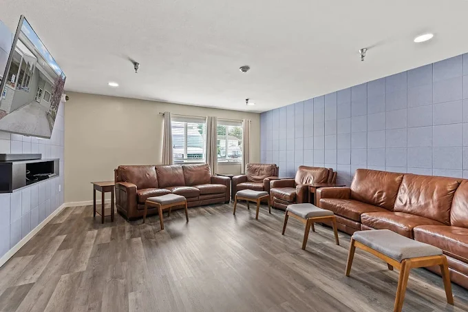 Lounge with leather sofas and ottomans