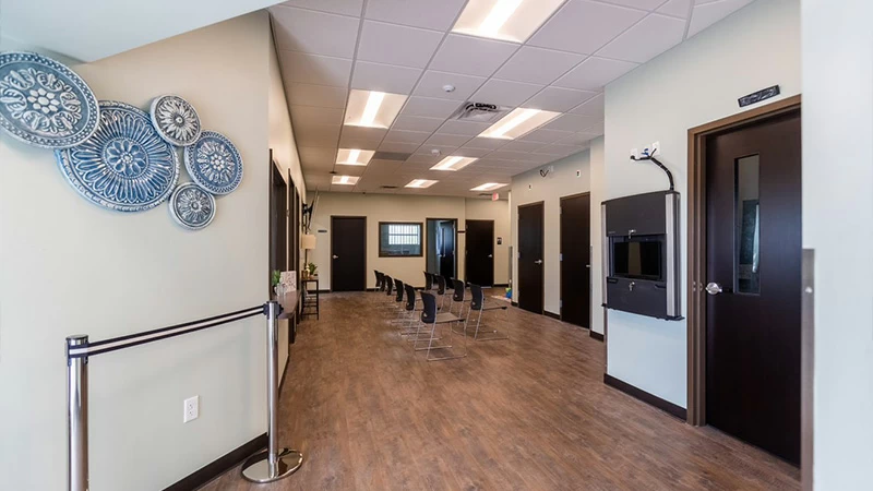 Waiting area with chairs lined along hallway wall