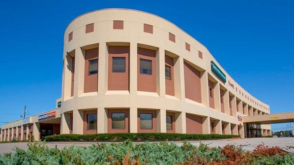 Facility exterior with large windows and signage.