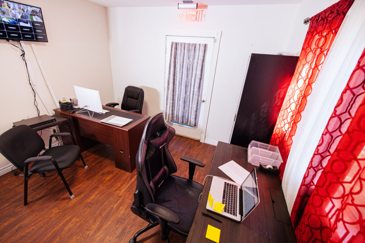 Consultation room with desks, chairs, and workstations