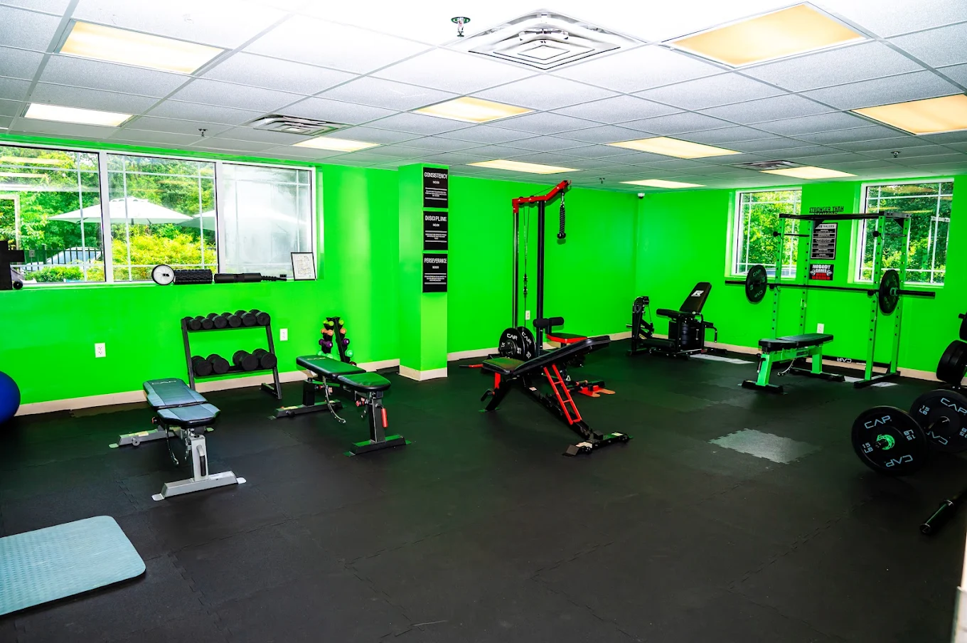 Fitness center with weight benches, dumbbells, and machines