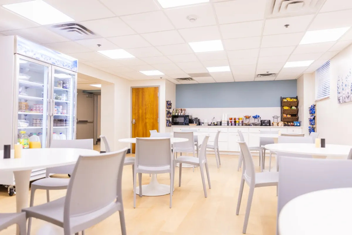 Dining area with tables and a self-serve food station.