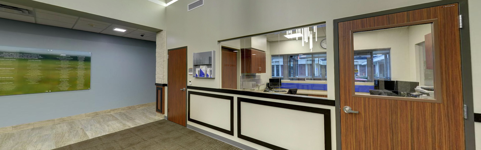 Reception desk with wood doors and glass windows in clinic