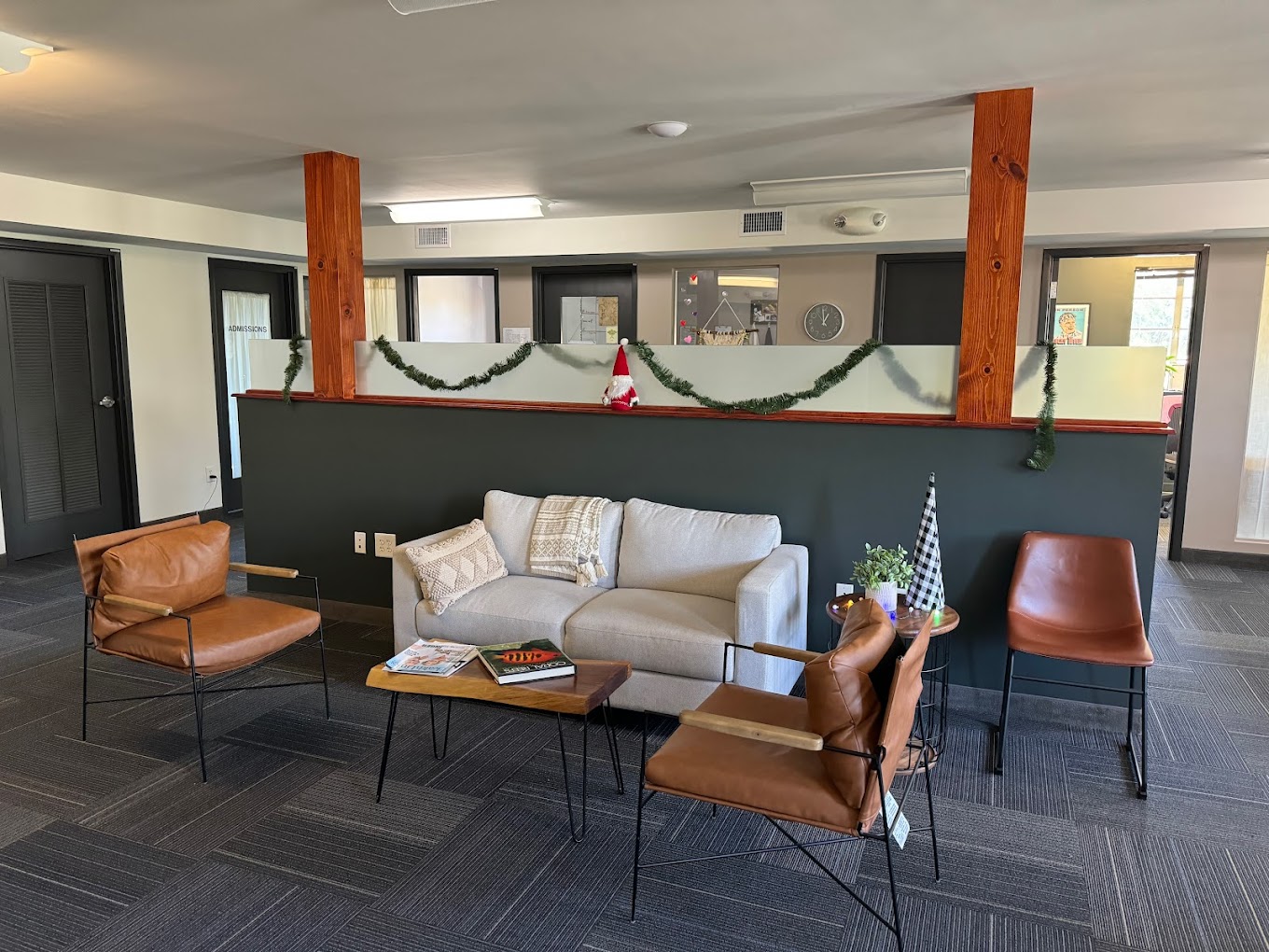 Cozy lounge area with brown leather chairs and a gray sofa.