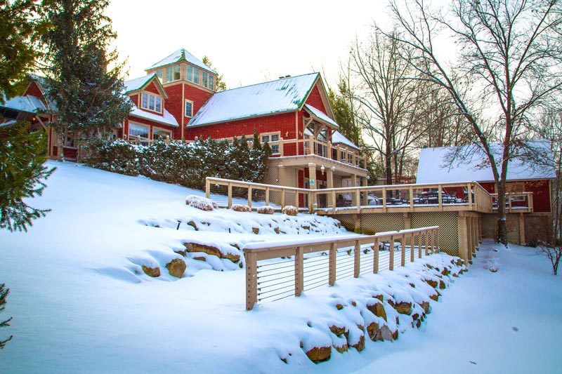Facility exterior with a deck and railings.